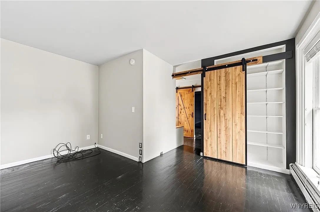 Clean, staged room with a barn-door closet